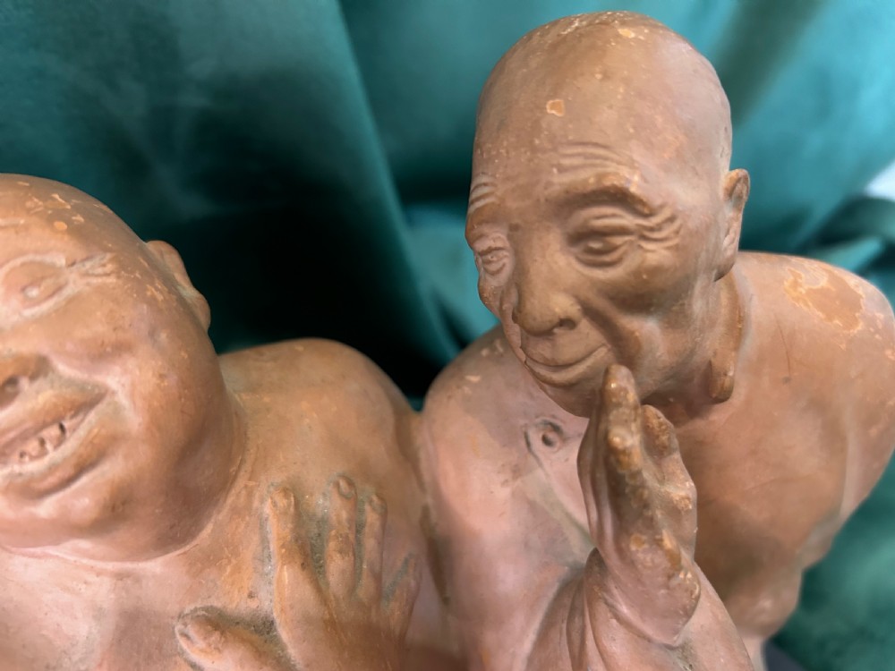 An Art Deco terracotta sculpture depicting three expressive figures mounted on a black marble base. View IV