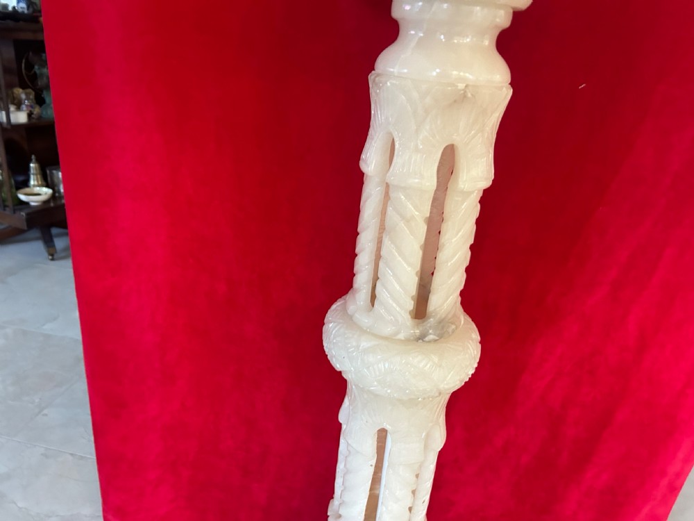 A tall carved cream alabaster plant stand featuring a round top, pierced central column, and stepped octagonal base. View VI