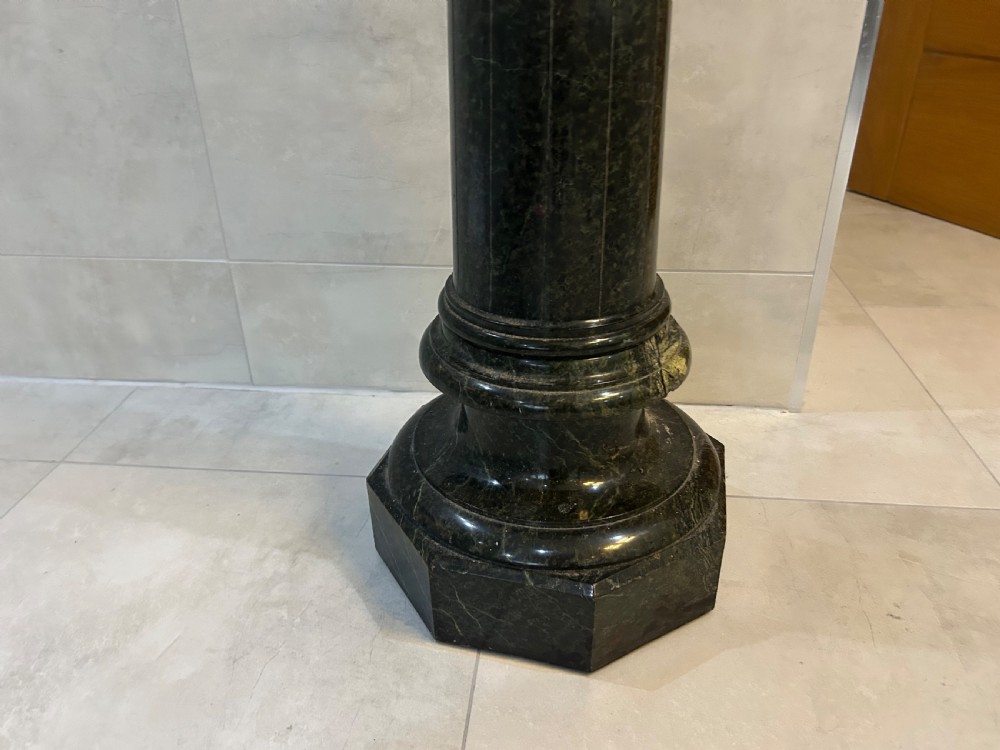A tall dark green marble pedestal featuring a spiralled shaft, a circular top capital, and an octagonal base. View II