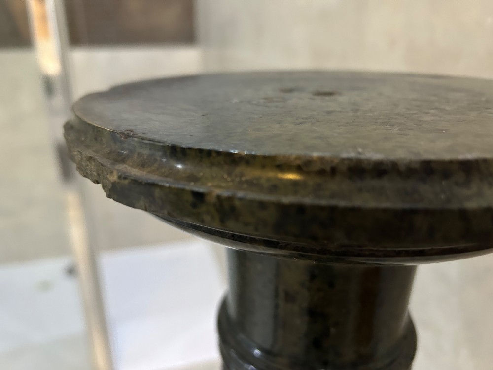 A tall dark green marble pedestal featuring a spiralled shaft, a circular top capital, and an octagonal base. View VI