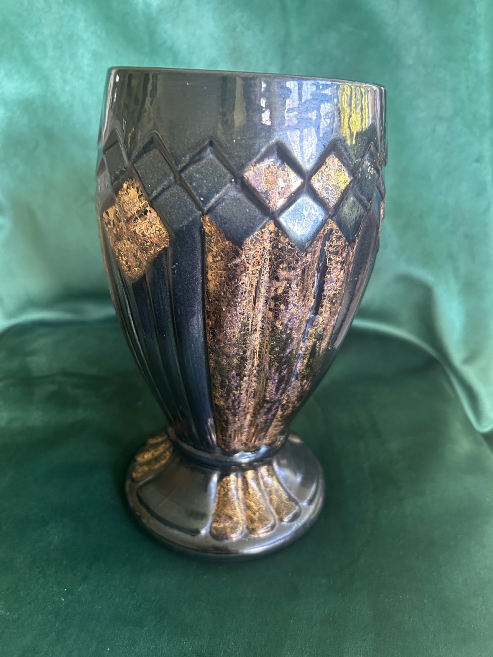 An Art Deco ceramic vase featuring a dark glaze with geometric diamond relief patterns highlighted in gold detailing. View IV