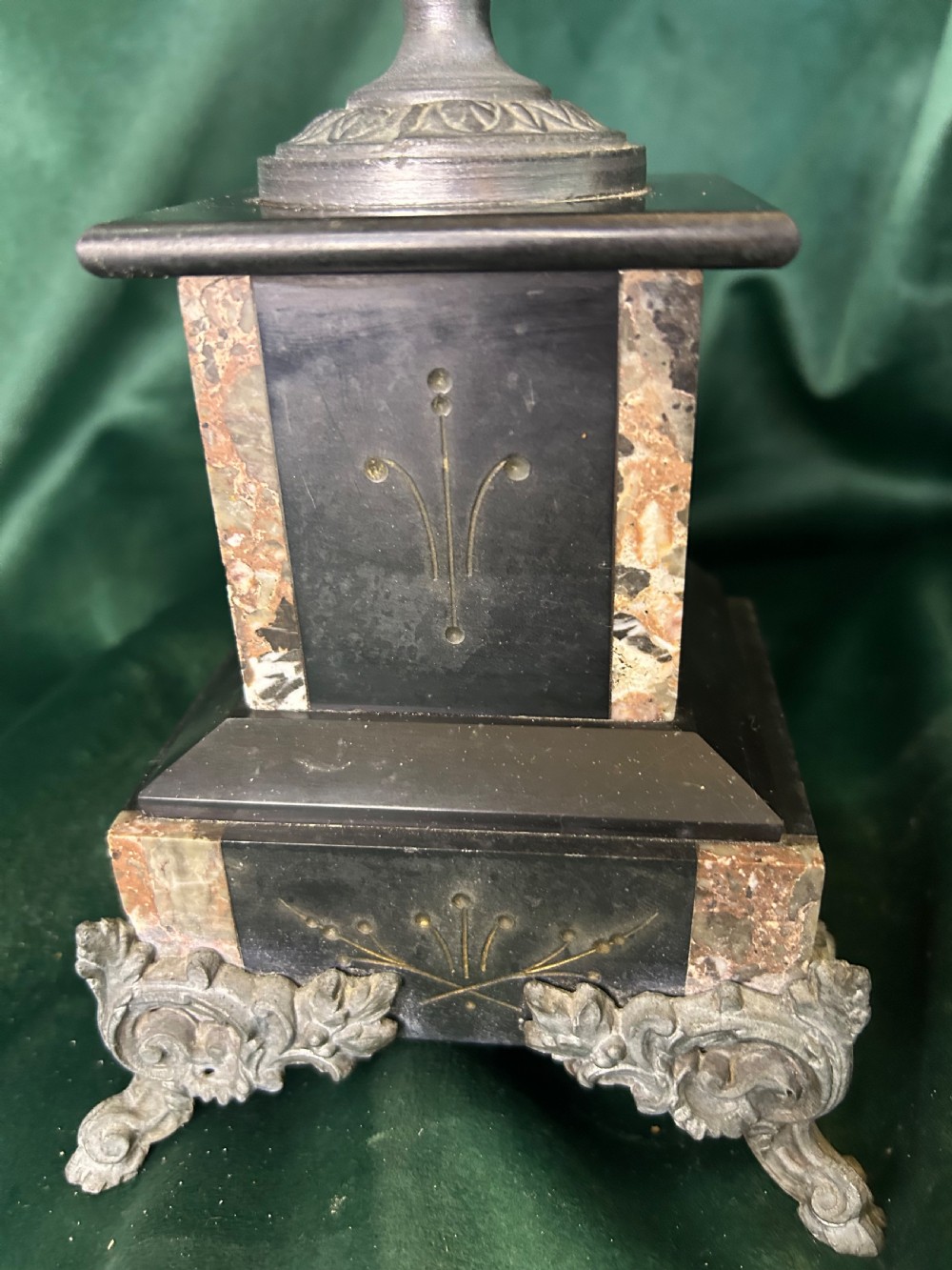A three-piece French black slate clock garniture set comprising a central mantel clock topped with a lion figure and flanked by two matching multi-branch candelabra. View VIII