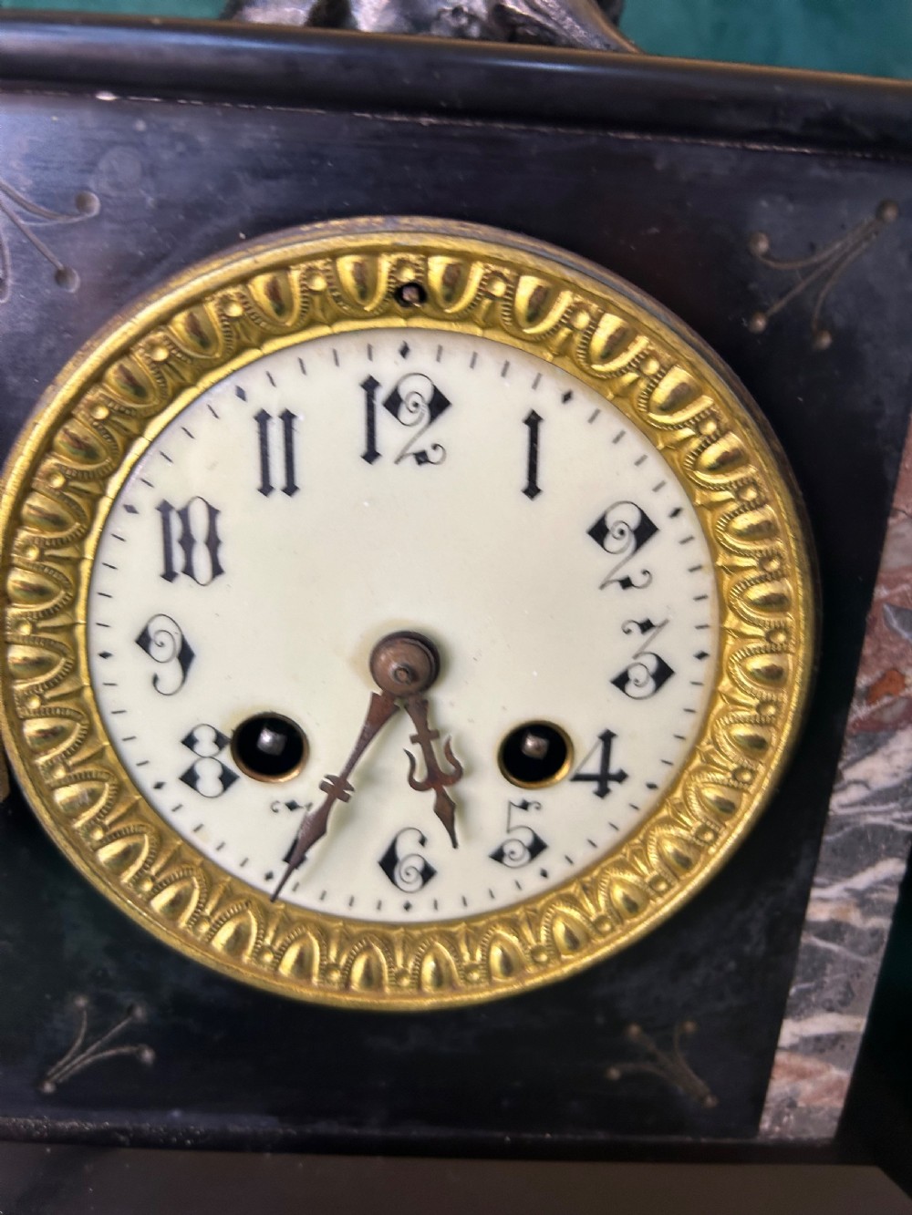 A three-piece French black slate clock garniture set comprising a central mantel clock topped with a lion figure and flanked by two matching multi-branch candelabra. View IX
