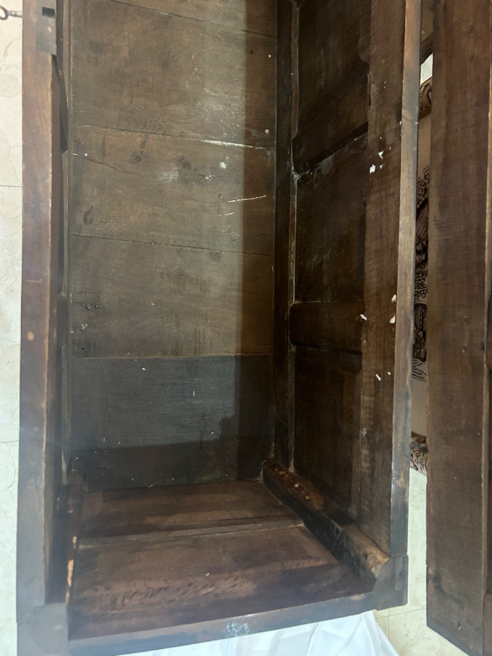 An 18th-century dark oak mule chest featuring a four-panel front, two base drawers with brass handles, and a hinged lid. View XVI