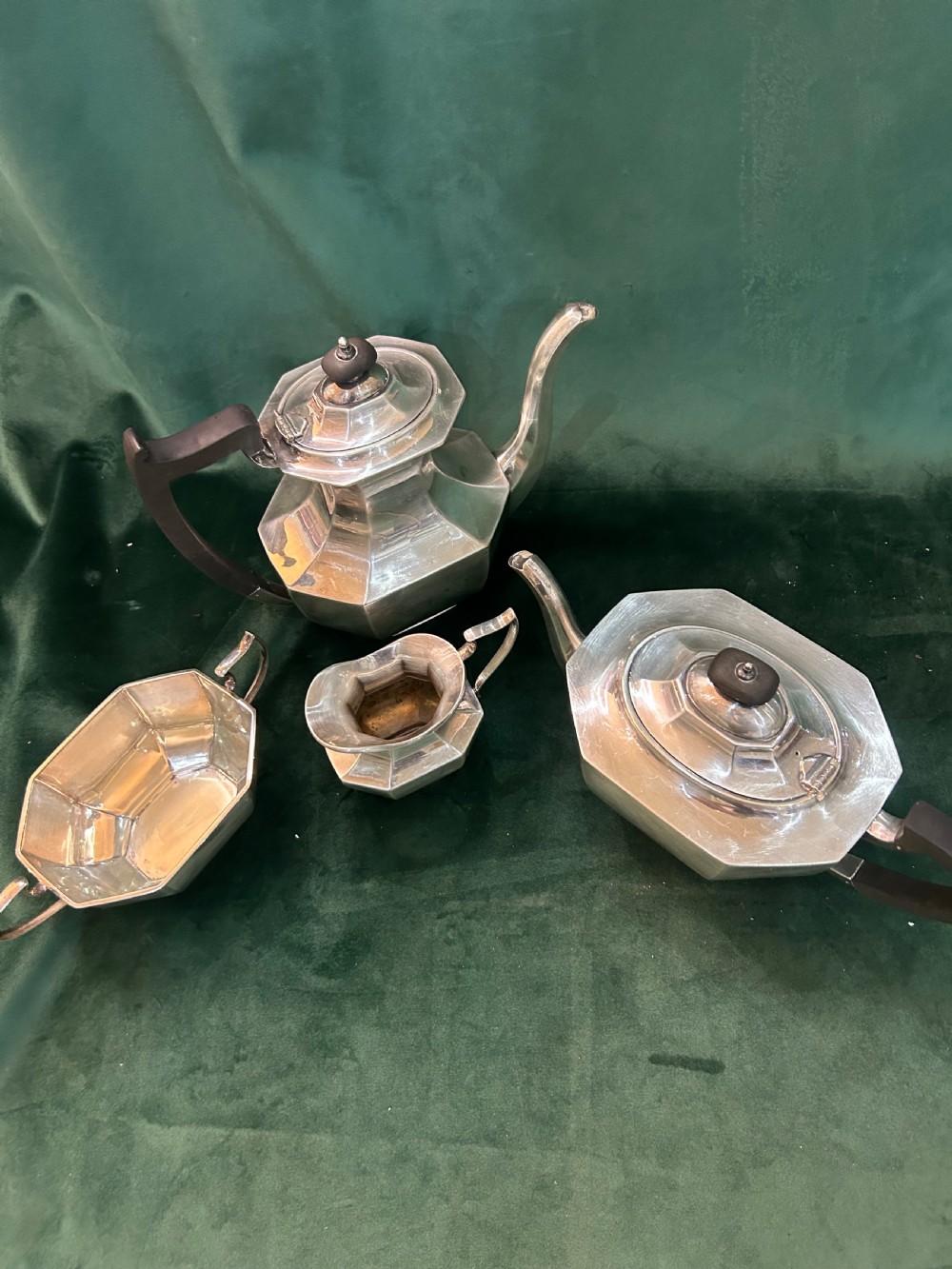A four-piece Art Deco silver tea and coffee set featuring faceted octagonal bodies, dark wooden handles, and stepped lids. View II