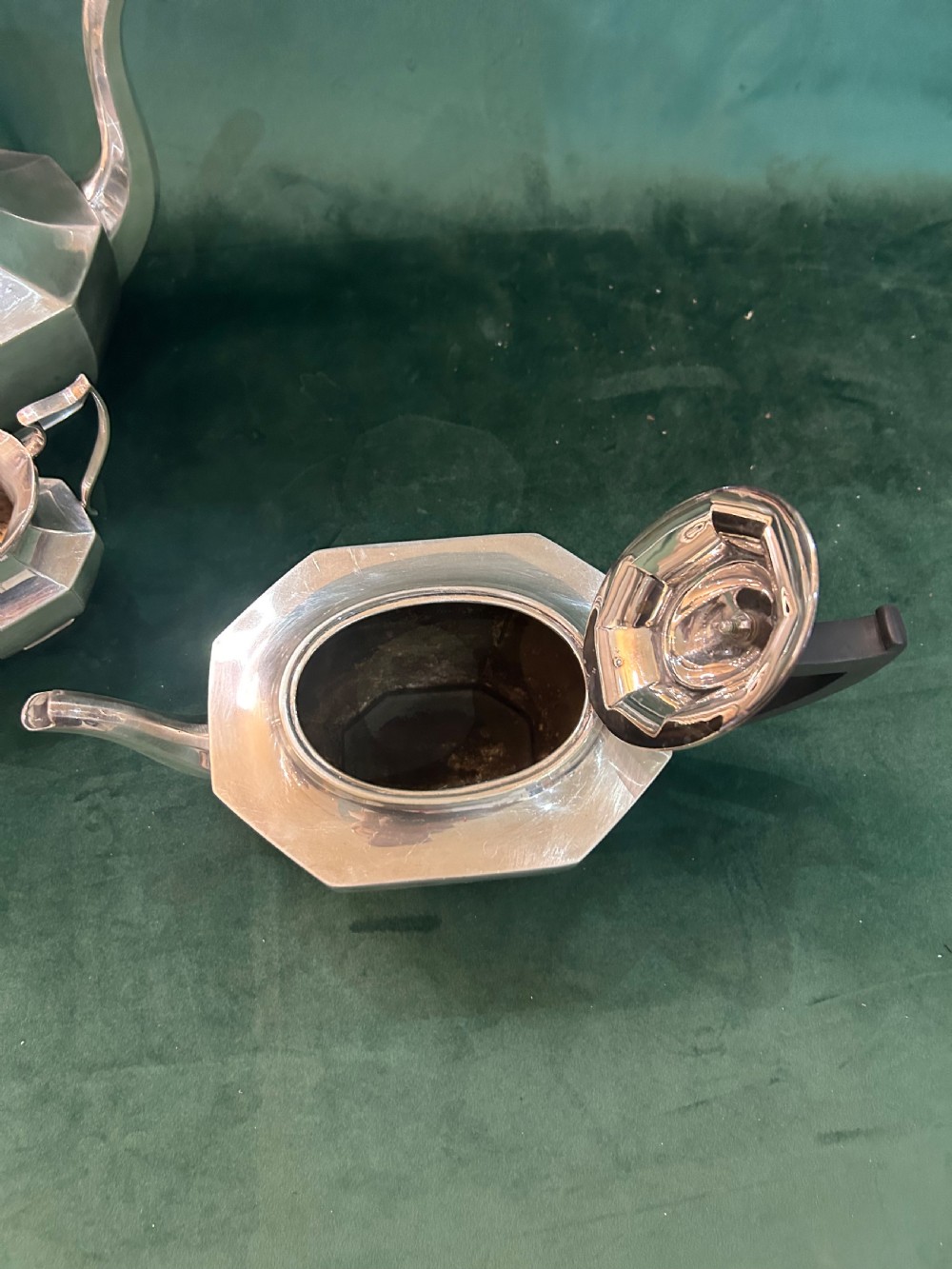 A four-piece Art Deco silver tea and coffee set featuring faceted octagonal bodies, dark wooden handles, and stepped lids. View III