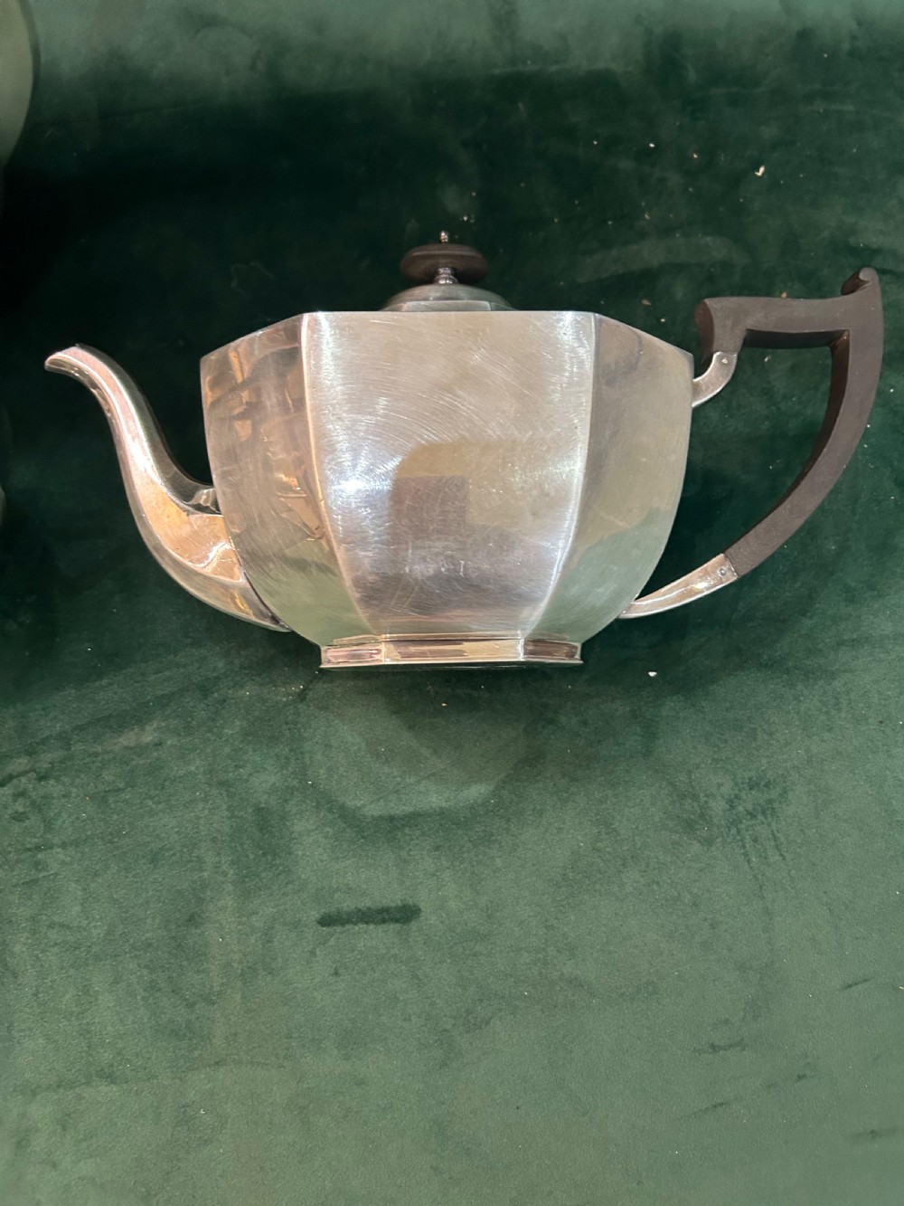 A four-piece Art Deco silver tea and coffee set featuring faceted octagonal bodies, dark wooden handles, and stepped lids. View IV