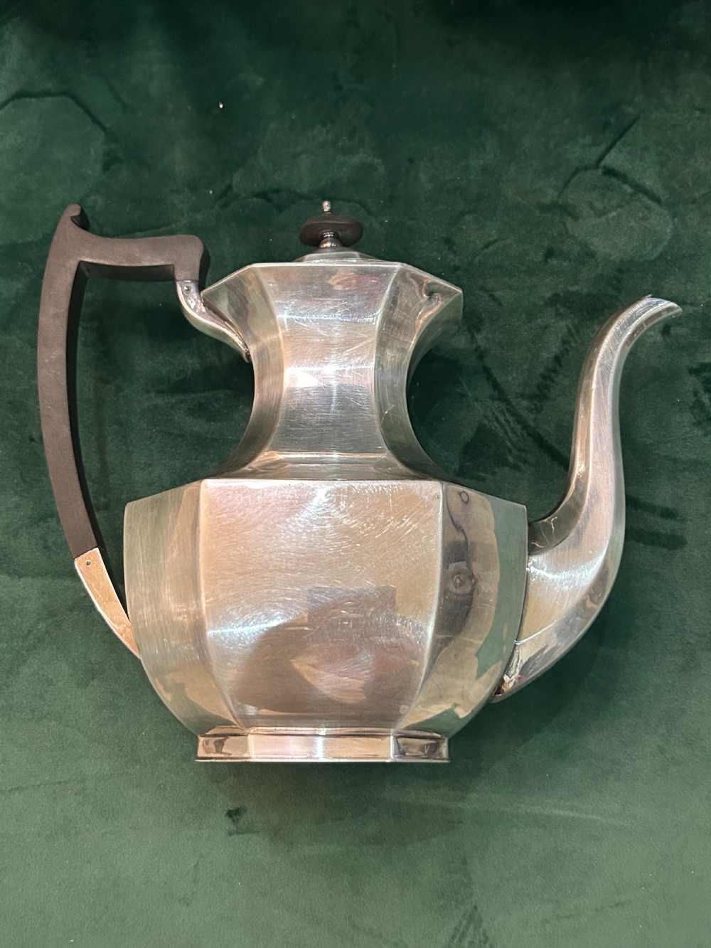 A four-piece Art Deco silver tea and coffee set featuring faceted octagonal bodies, dark wooden handles, and stepped lids. View VIII