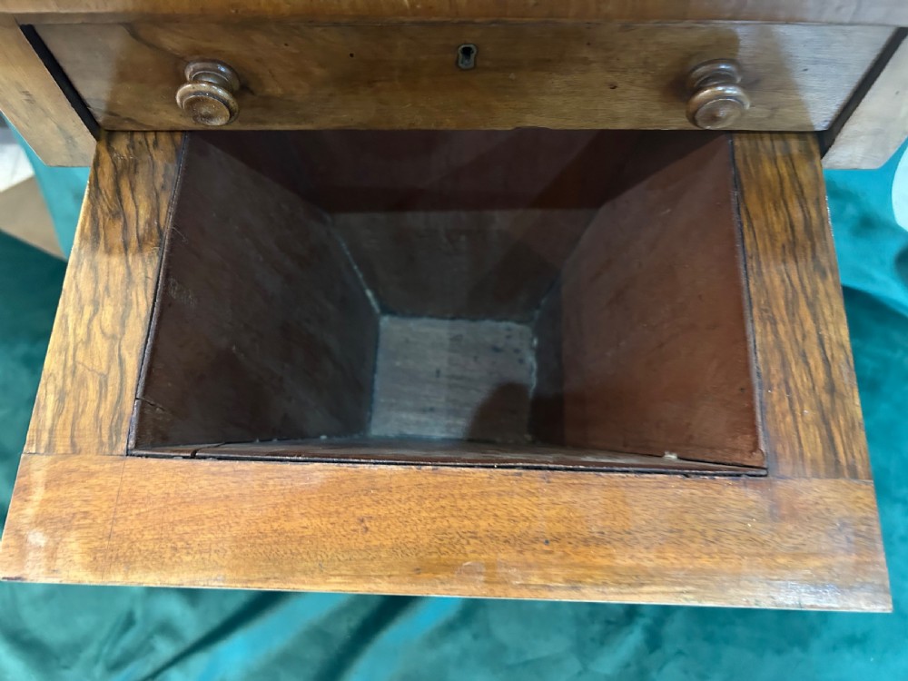 A Victorian warm brown wood games work table featuring an inlaid chessboard top, a single drawer, a damask fabric sewing well, and a turned pedestal base. View VIII