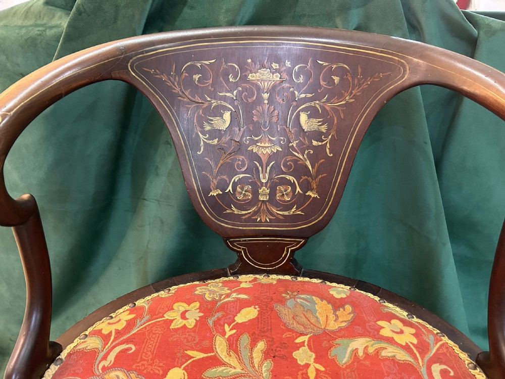 A nineteenth-century dark mahogany tub chair featuring intricate floral marquetry on the back splat and cabriole legs, fitted with a red floral upholstered seat. View II