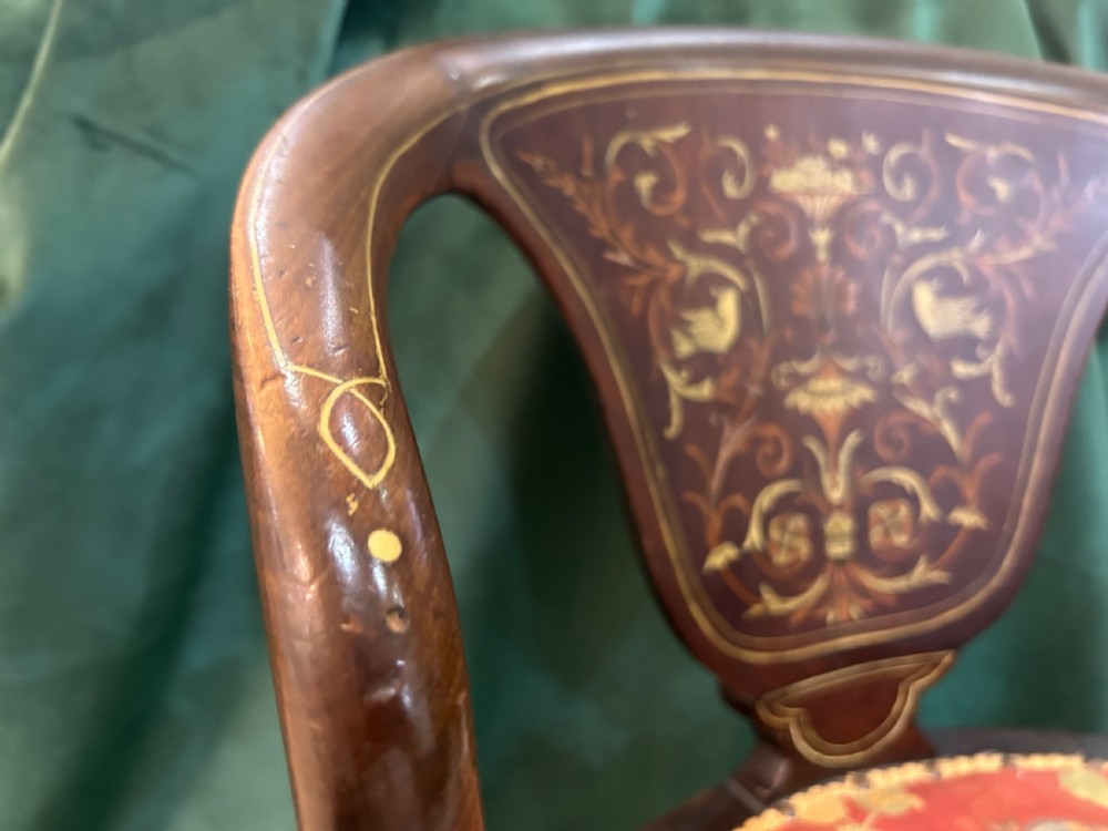 A nineteenth-century dark mahogany tub chair featuring intricate floral marquetry on the back splat and cabriole legs, fitted with a red floral upholstered seat. View IV