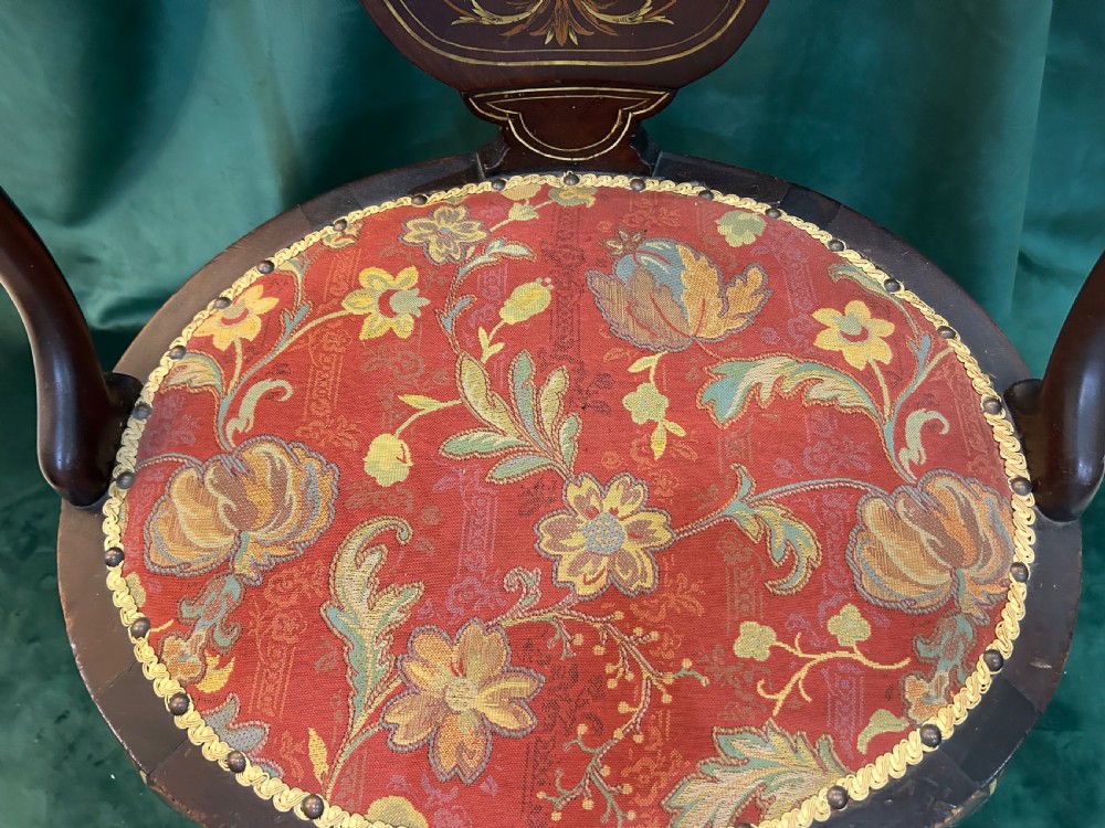 A nineteenth-century dark mahogany tub chair featuring intricate floral marquetry on the back splat and cabriole legs, fitted with a red floral upholstered seat. View VI