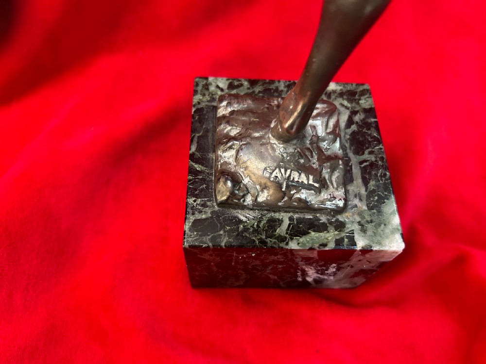 An Art Deco silver-plated figure of a female dancer balanced on one foot atop a square dark marble base. View II