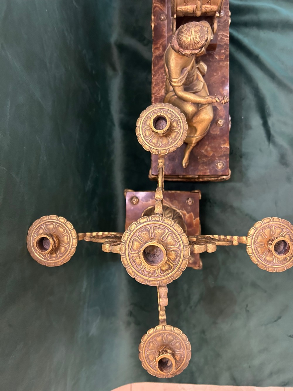 An antique three-piece French ormolu clock garniture featuring a central mantel clock decorated with a classical female figurine and marble base, flanked by two matching five-arm candelabra. View IX