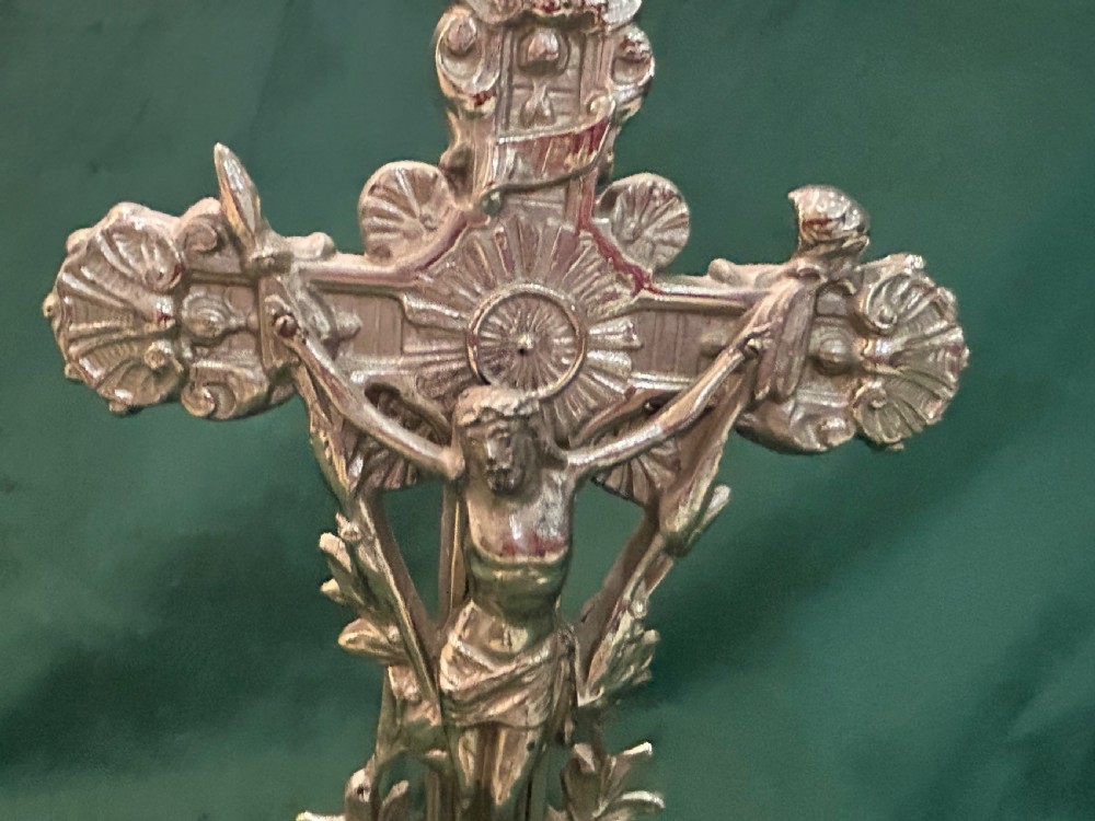 An antique silver metal standing altar cross featuring shell motif terminals, a figure of Christ, and two kneeling angels on a moulded pedestal base. View VI