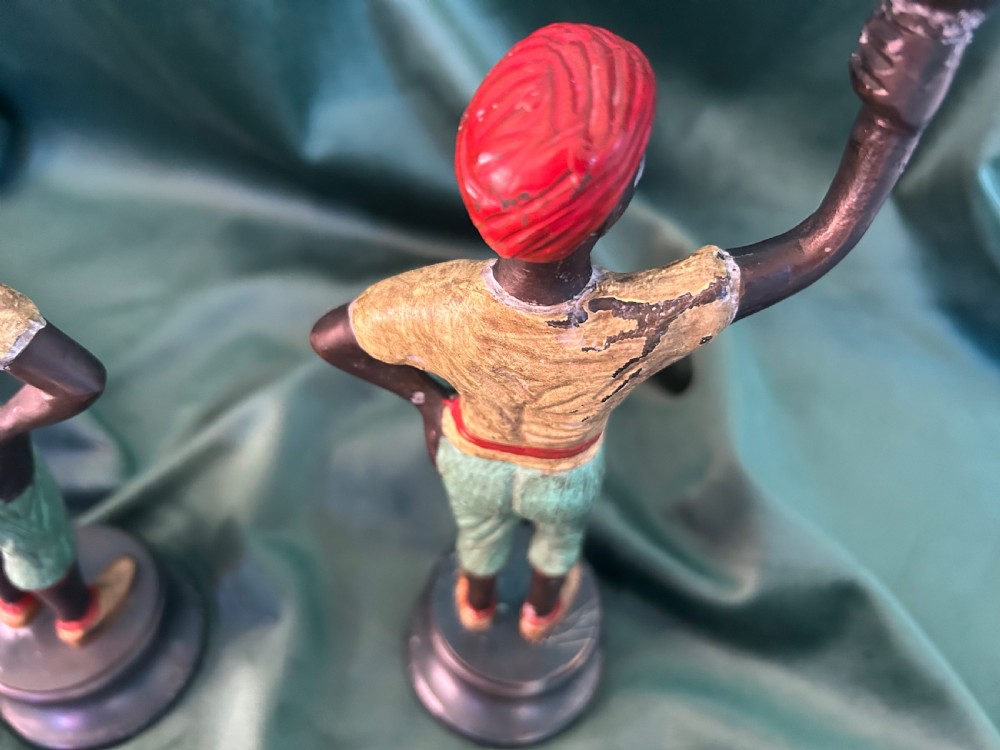 A pair of early 20th century polychrome painted cast metal figural candlesticks with floral sconces. View V