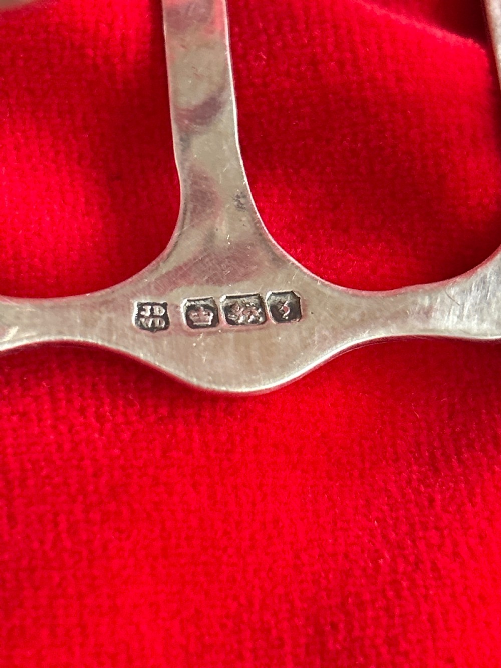 A polished silver toast rack featuring arched wire dividers, a central ring handle, and a six-slice capacity. View III