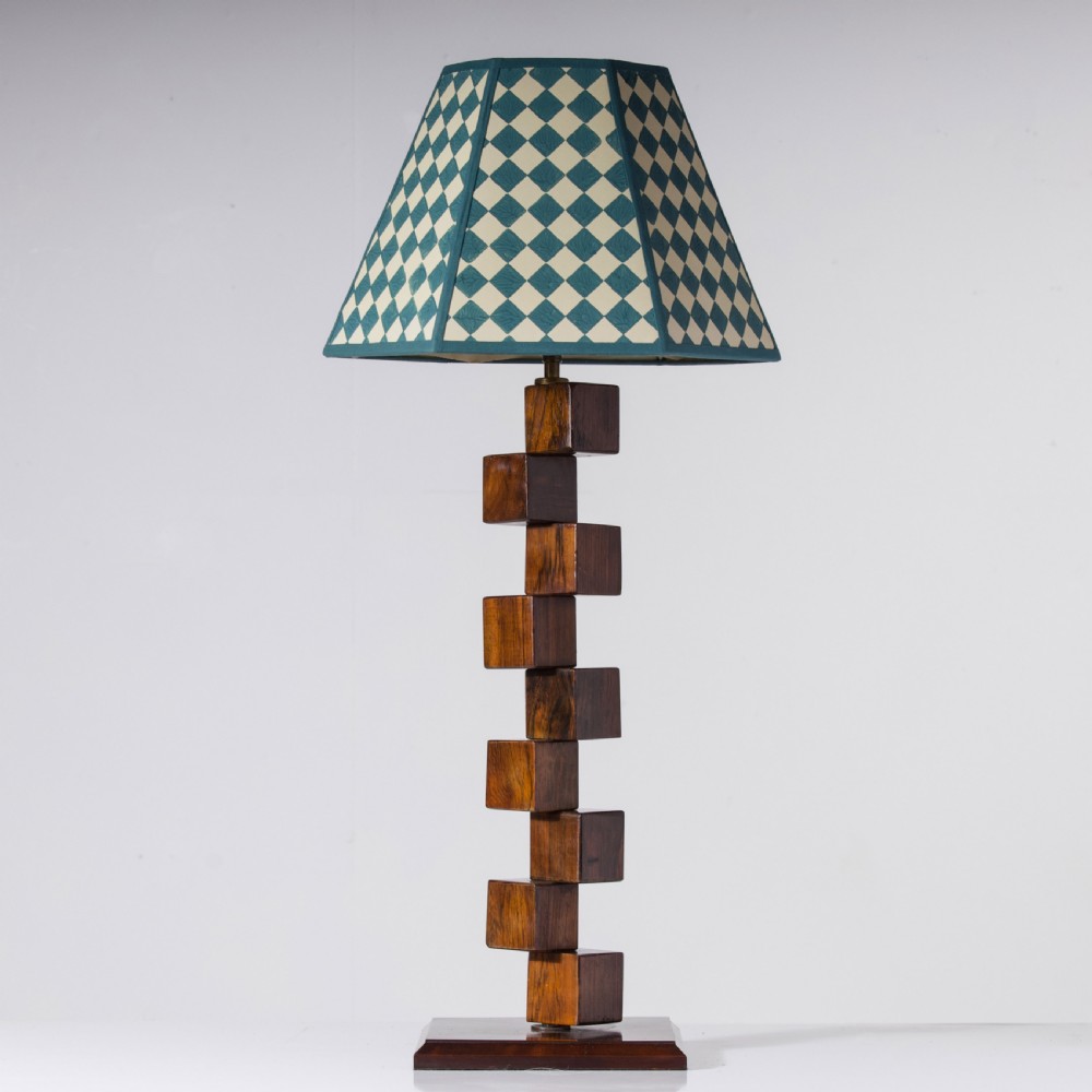 A mid-century modern wooden table lamp base constructed from offset stacked cubes terminating in a brass bulb fitting on a rectangular plinth. View II