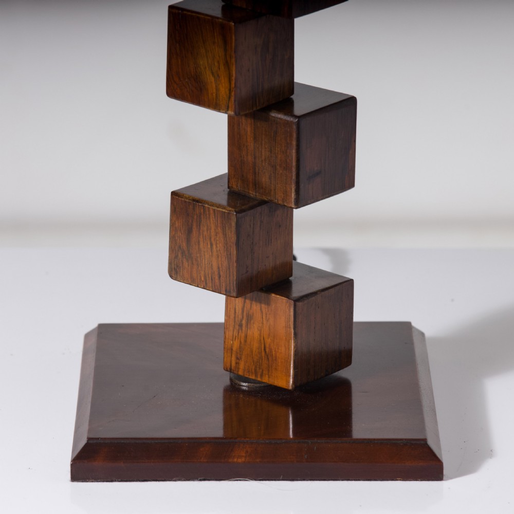 A mid-century modern wooden table lamp base constructed from offset stacked cubes terminating in a brass bulb fitting on a rectangular plinth. View VI
