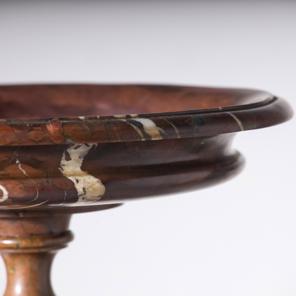 A carved reddish-brown marble tazza featuring a wide shallow dish, turned central stem, and circular moulded base. View III