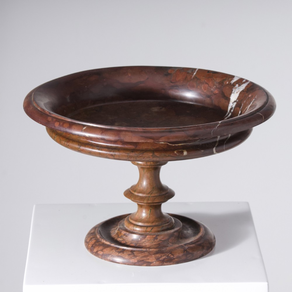 A carved reddish-brown marble tazza featuring a wide shallow dish, turned central stem, and circular moulded base. View IV