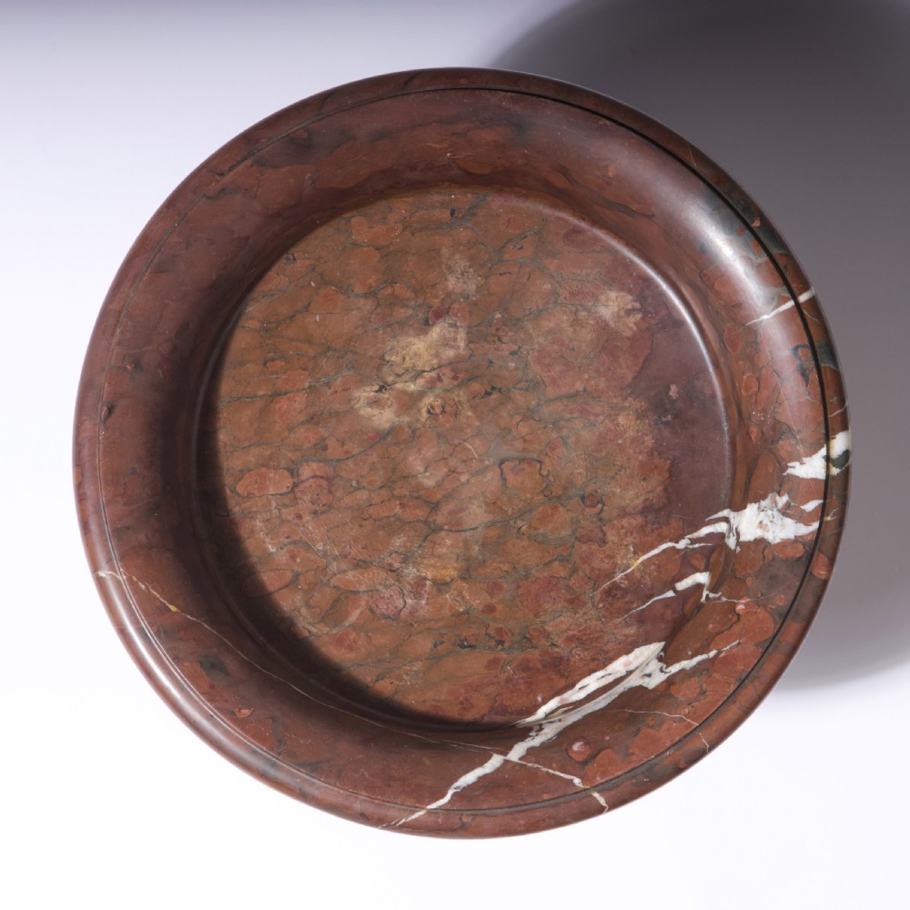 A carved reddish-brown marble tazza featuring a wide shallow dish, turned central stem, and circular moulded base. View VIII