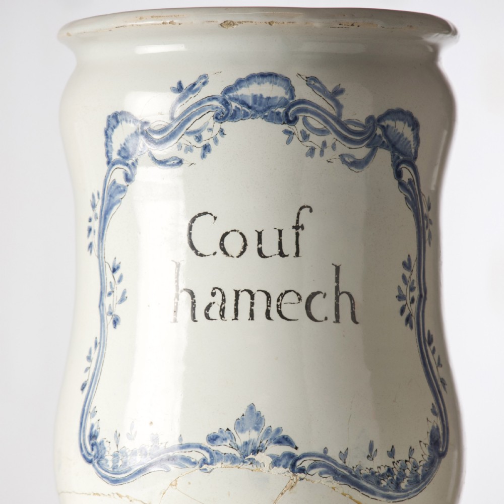A cylindrical 19th-century tin-glazed ceramic pharmacy jar featuring a blue painted scrollwork cartouche with Latin text. View III