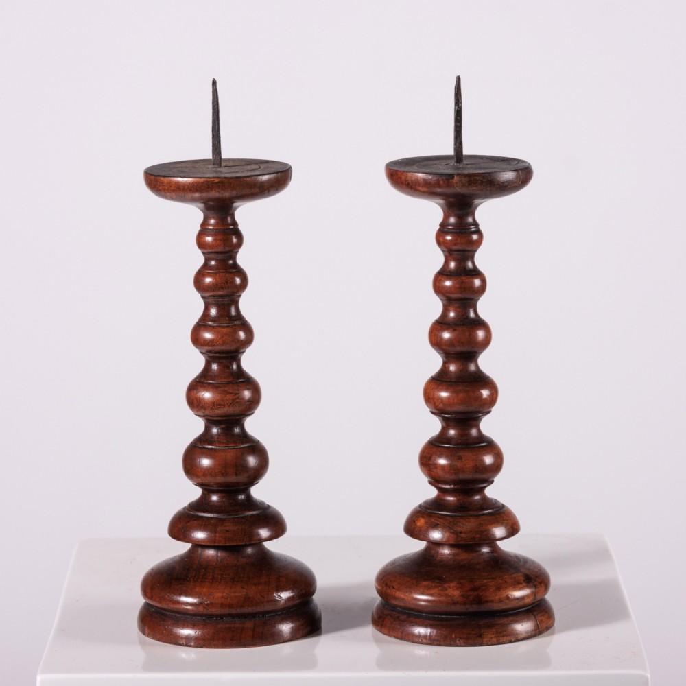 A pair of 18th-century turned dark wood pricket candlesticks featuring iron spikes and stepped circular bases. View III