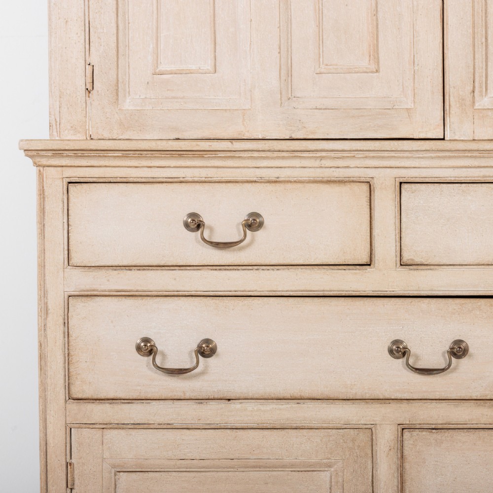 A large 19th-century pale timber dresser featuring a scalloped cornice, panelled upper cupboard doors, and multiple drawers with brass drop handles above a scalloped base. View VII