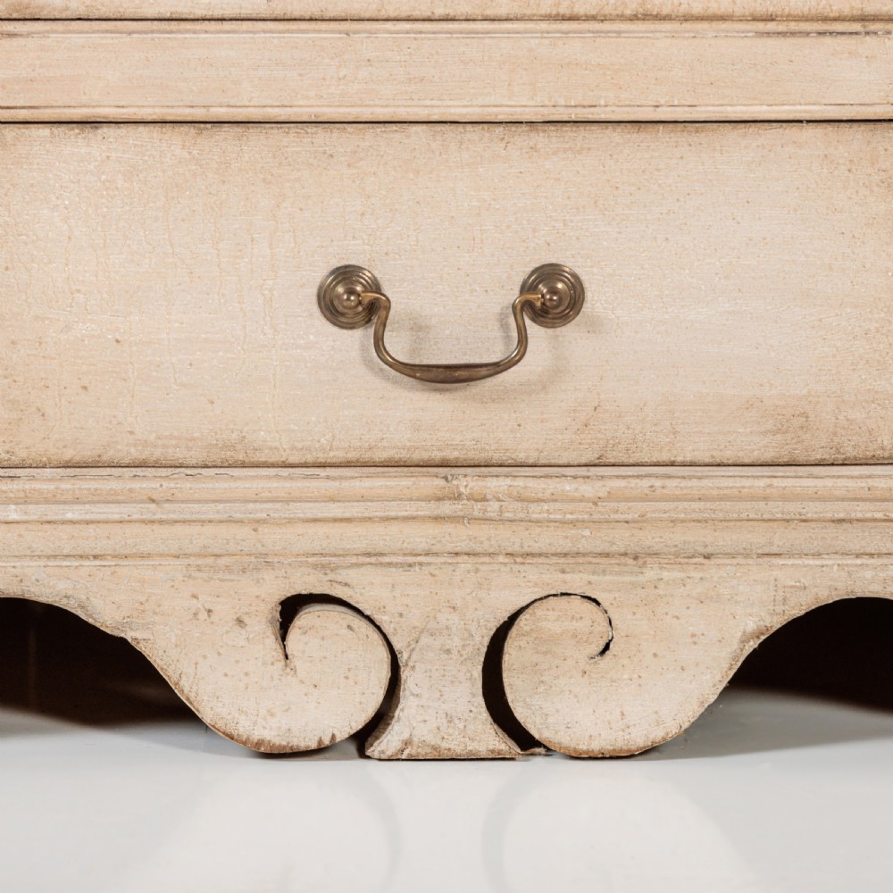A large 19th-century pale timber dresser featuring a scalloped cornice, panelled upper cupboard doors, and multiple drawers with brass drop handles above a scalloped base. View VIII