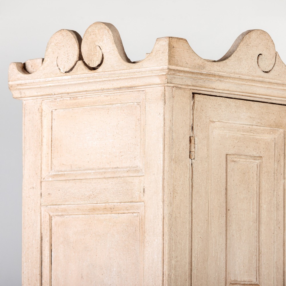 A large 19th-century pale timber dresser featuring a scalloped cornice, panelled upper cupboard doors, and multiple drawers with brass drop handles above a scalloped base. View XIII