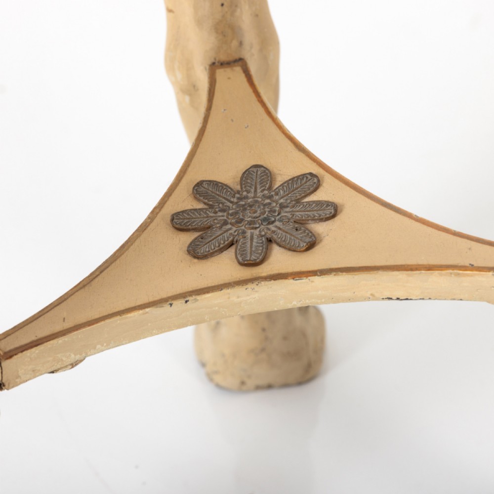 A 19th-century French Empire style circular gueridon table with a pink marble top supported by three carved cream-painted caryatid legs terminating in paw feet. View VIII
