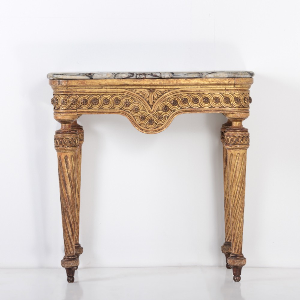 A 19th-century French giltwood console table featuring a grey and white marble top, carved guilloche apron, and spirally fluted tapered legs. View II