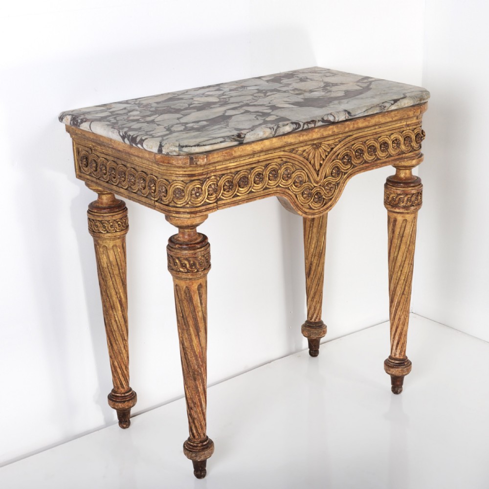 A 19th-century French giltwood console table featuring a grey and white marble top, carved guilloche apron, and spirally fluted tapered legs. View III