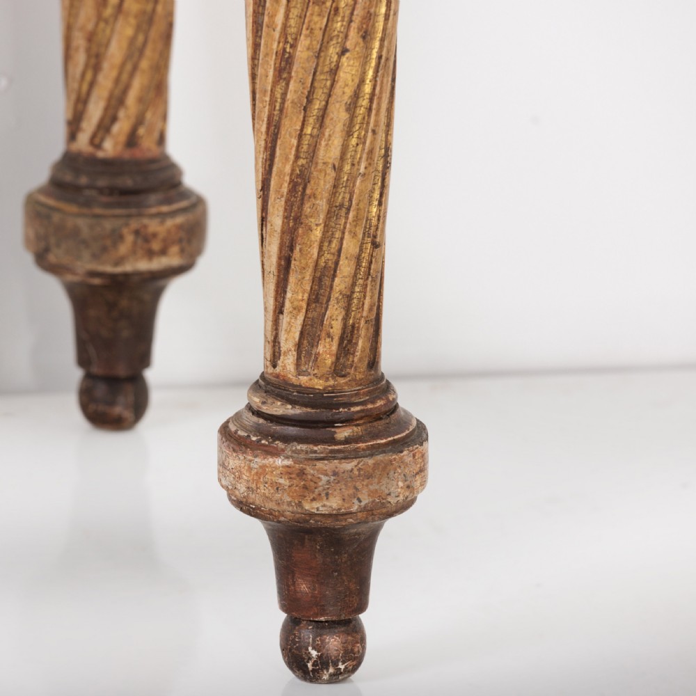 A 19th-century French giltwood console table featuring a grey and white marble top, carved guilloche apron, and spirally fluted tapered legs. View VI