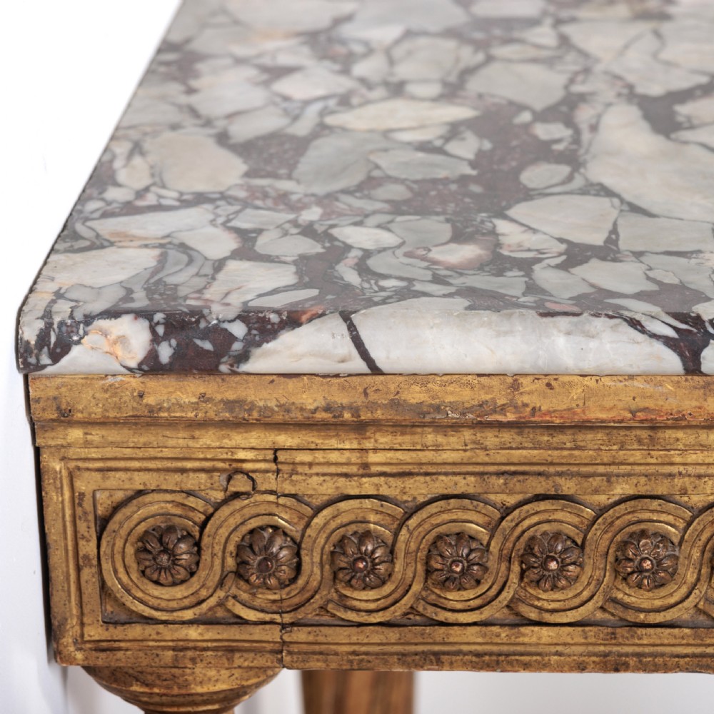 A 19th-century French giltwood console table featuring a grey and white marble top, carved guilloche apron, and spirally fluted tapered legs. View VII
