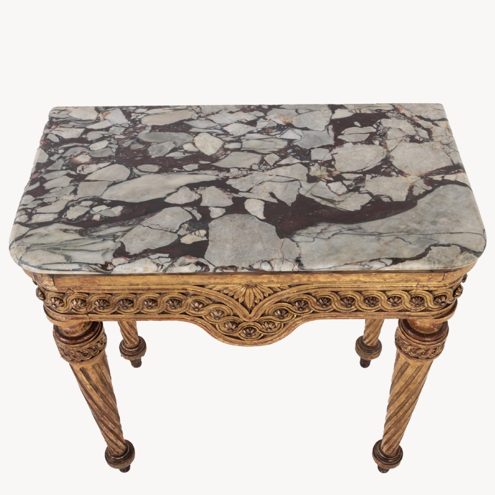 A 19th-century French giltwood console table featuring a grey and white marble top, carved guilloche apron, and spirally fluted tapered legs. View VIII