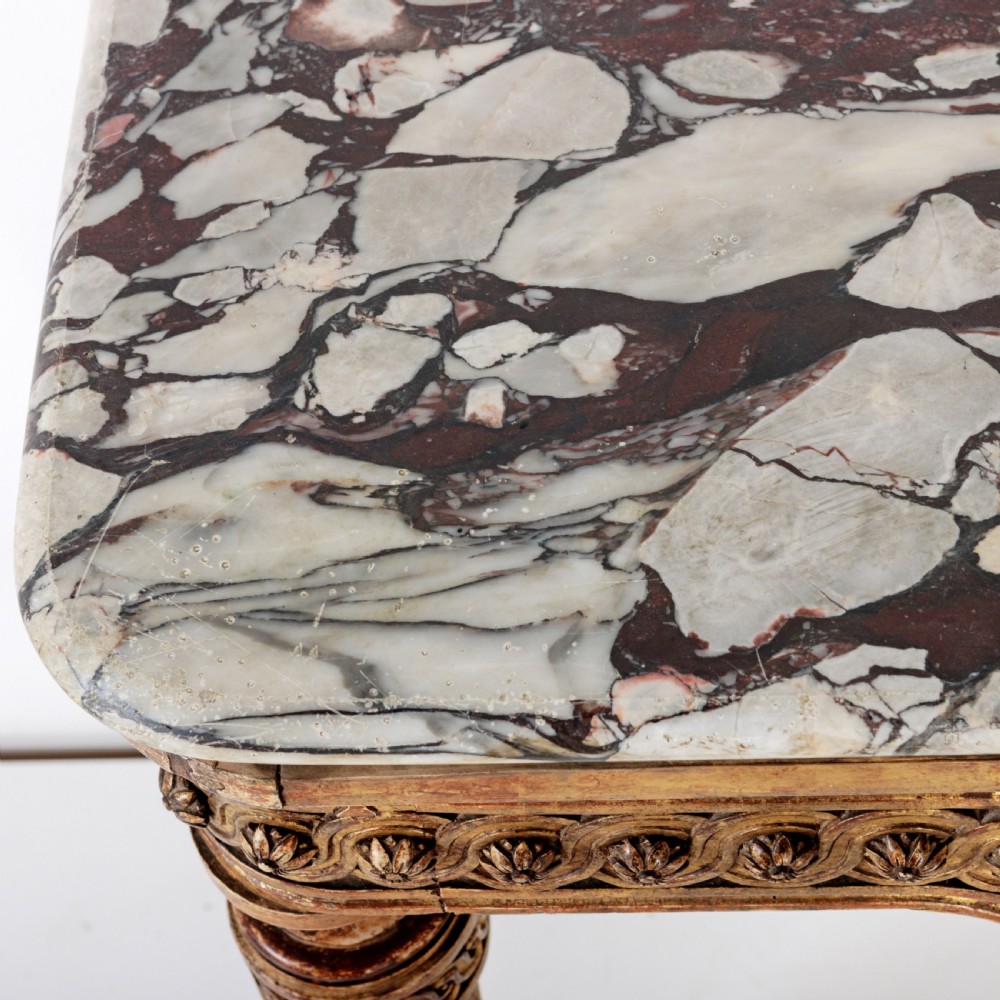 A 19th-century French giltwood console table featuring a grey and white marble top, carved guilloche apron, and spirally fluted tapered legs. View X
