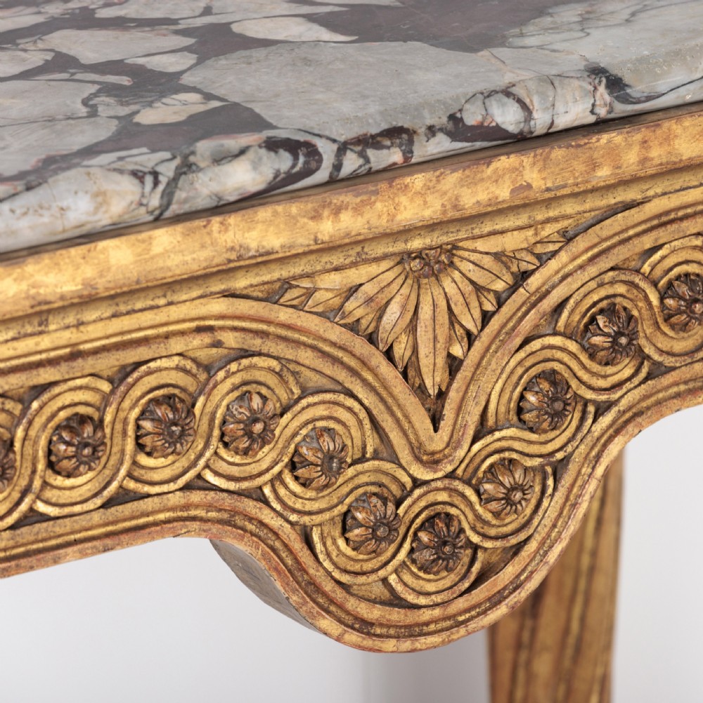 A 19th-century French giltwood console table featuring a grey and white marble top, carved guilloche apron, and spirally fluted tapered legs. View XI