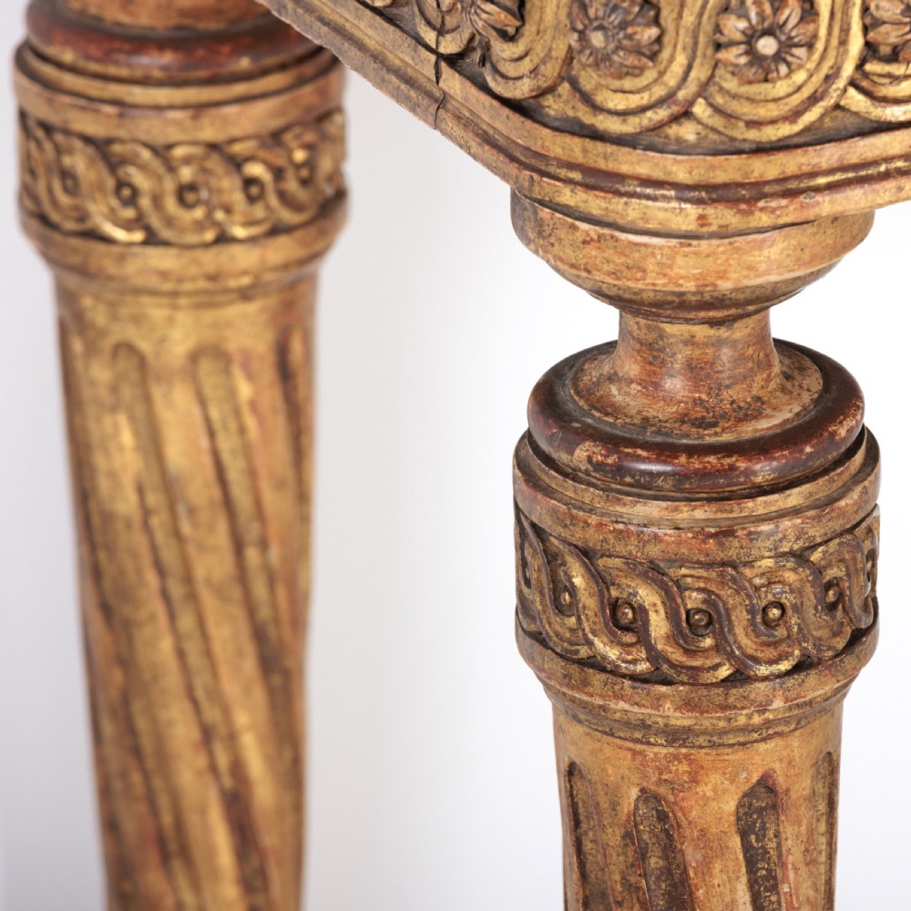 A 19th-century French giltwood console table featuring a grey and white marble top, carved guilloche apron, and spirally fluted tapered legs. View XIII