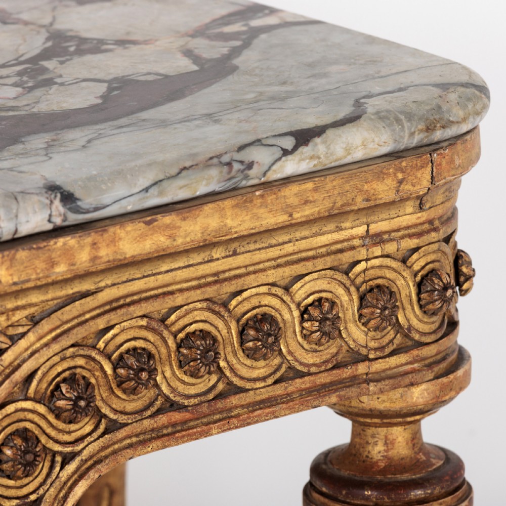 A 19th-century French giltwood console table featuring a grey and white marble top, carved guilloche apron, and spirally fluted tapered legs. View XIV