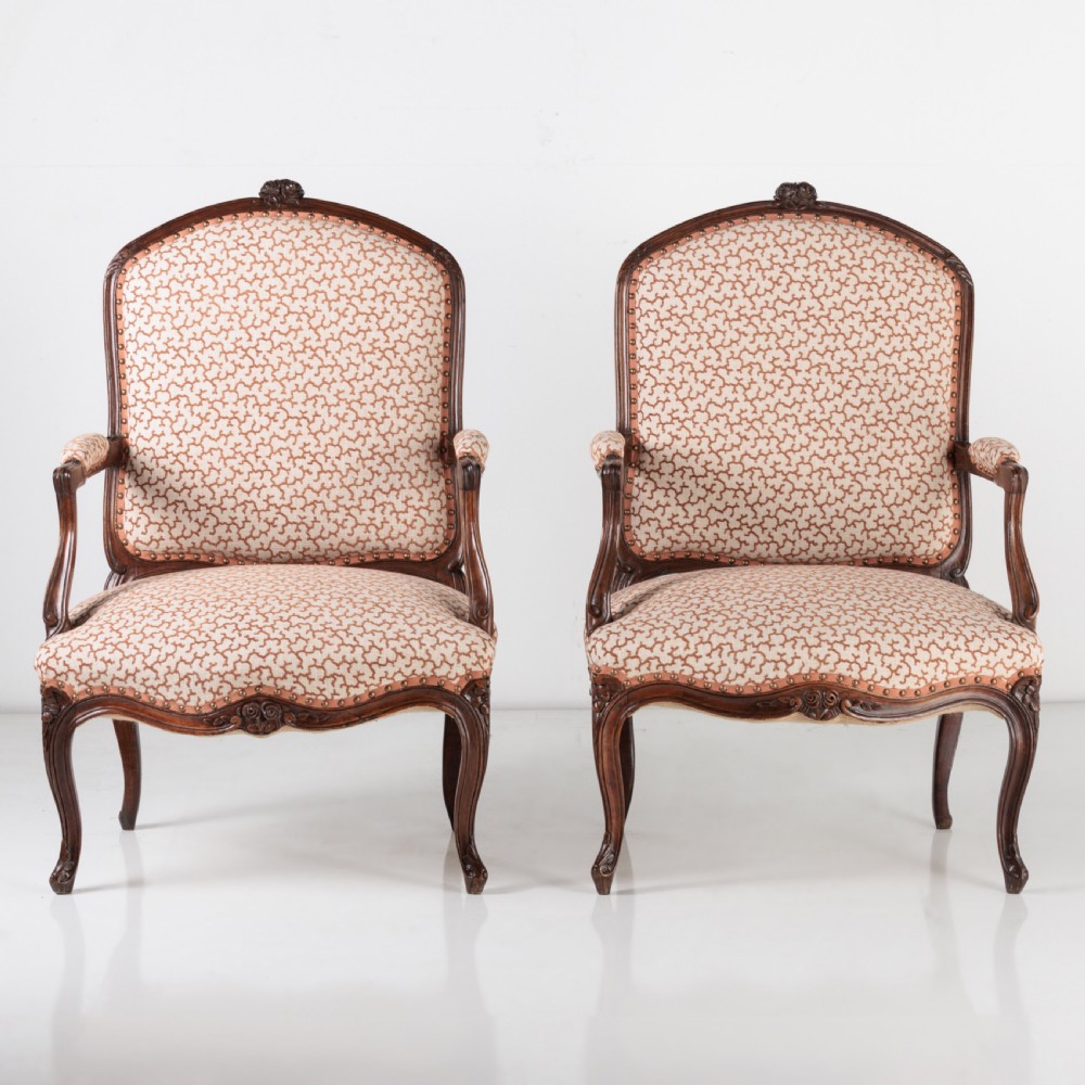 A pair of 19th-century French Louis XV style fauteuil armchairs with carved walnut frames, cabriole legs, brass stud trim, and patterned cream and brown upholstery. View III