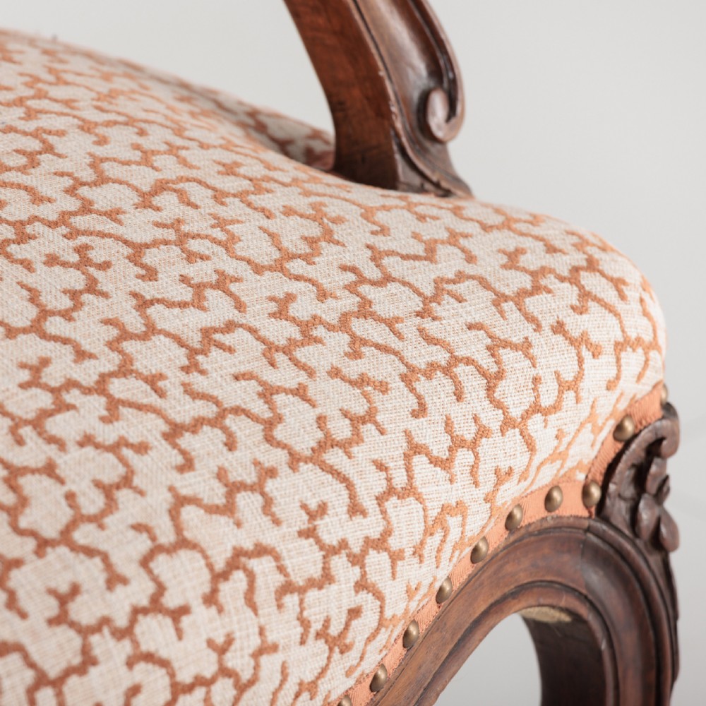 A pair of 19th-century French Louis XV style fauteuil armchairs with carved walnut frames, cabriole legs, brass stud trim, and patterned cream and brown upholstery. View XI