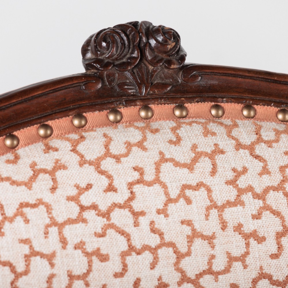 A pair of 19th-century French Louis XV style fauteuil armchairs with carved walnut frames, cabriole legs, brass stud trim, and patterned cream and brown upholstery. View XII