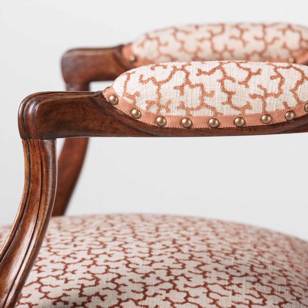 A pair of 19th-century French Louis XV style fauteuil armchairs with carved walnut frames, cabriole legs, brass stud trim, and patterned cream and brown upholstery. View XV