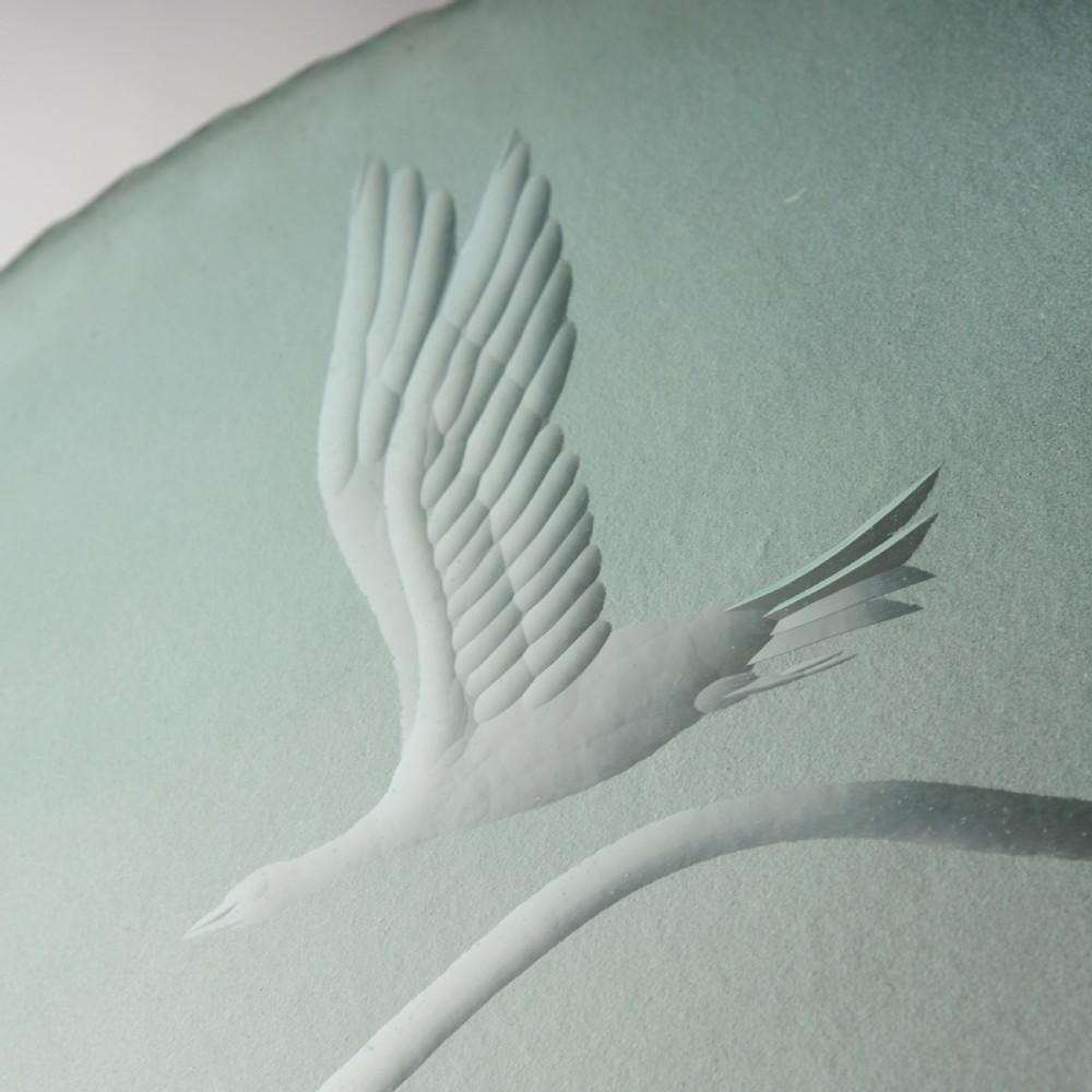 A shallow pale green frosted glass dish ceiling light featuring etched flying crane motifs and patinated metal central fittings. View II