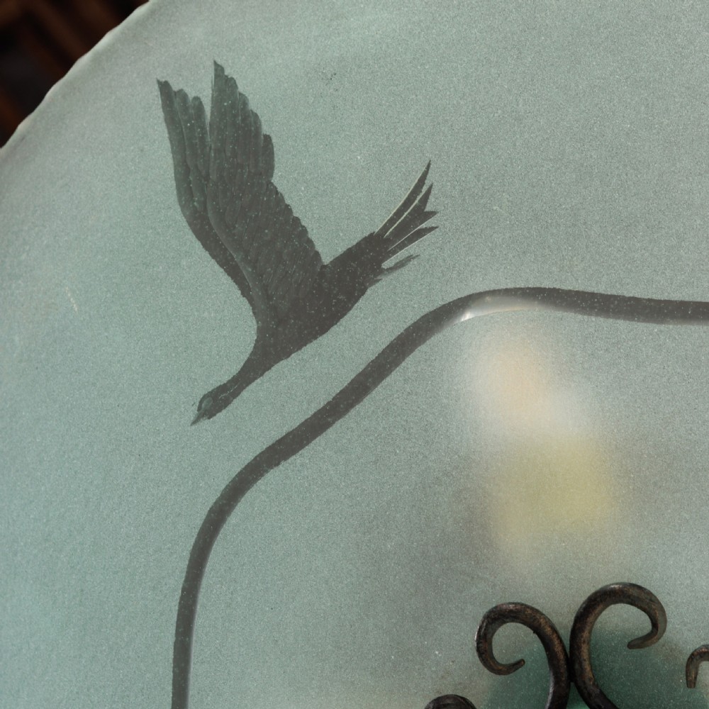 A shallow pale green frosted glass dish ceiling light featuring etched flying crane motifs and patinated metal central fittings. View IV
