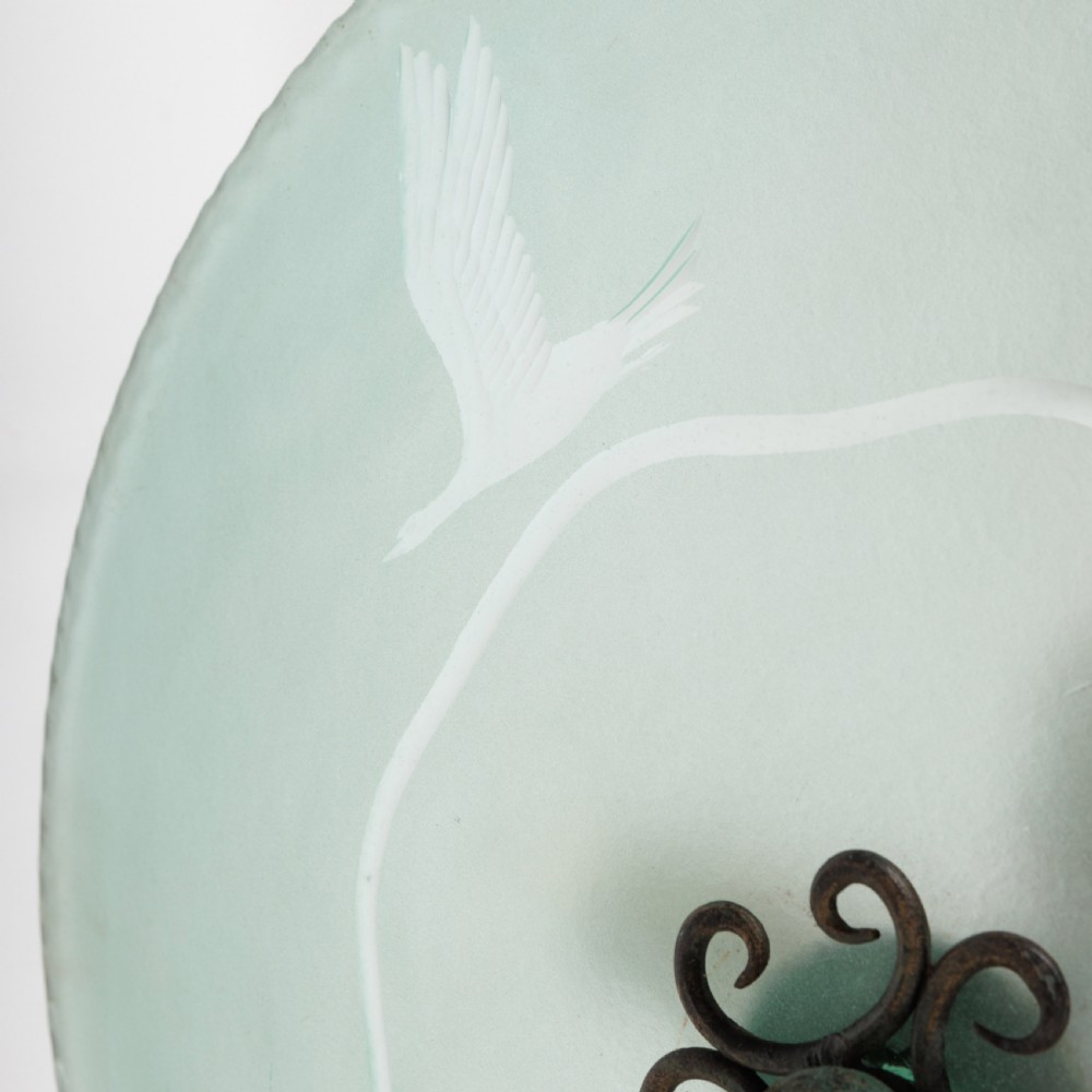 A shallow pale green frosted glass dish ceiling light featuring etched flying crane motifs and patinated metal central fittings. View VIII