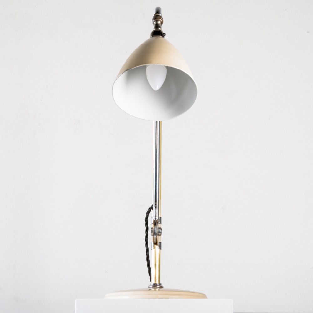 A 1930s Bestlite desk lamp featuring a cream enamelled shade and base, a curved chrome gooseneck arm, and an adjustable brass stem. View VI