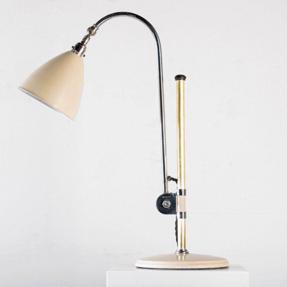 A 1930s Bestlite desk lamp featuring a cream enamelled shade and base, a curved chrome gooseneck arm, and an adjustable brass stem. View VII
